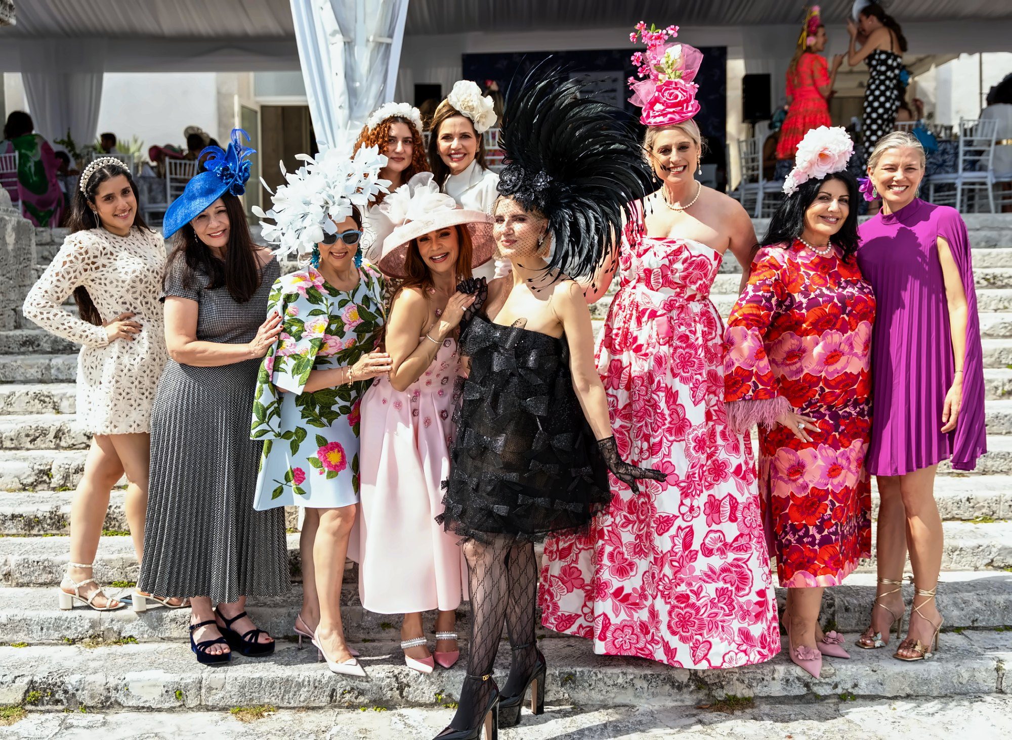 Guests in statement hats on the steps at Vizcaya