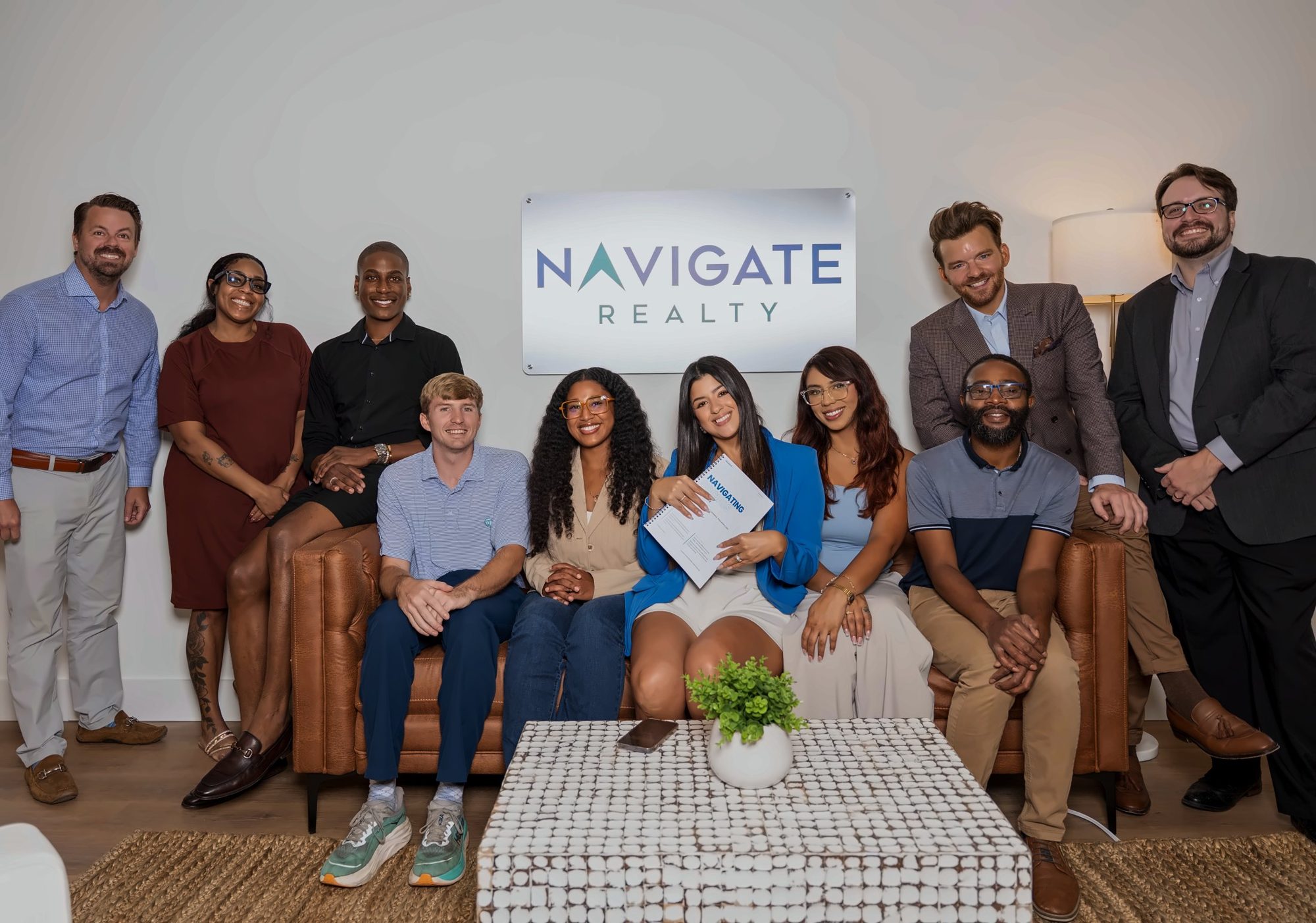 Navigate Realty agents on a leather sofa after the Navigating Socials workshop